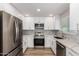 Modern kitchen with stainless steel appliances, white cabinets, and granite countertops at 3014 W Zachary Dr, Phoenix, AZ 85027
