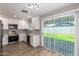 Bright, updated kitchen with stainless steel appliances, white cabinets, and view to backyard at 3014 W Zachary Dr, Phoenix, AZ 85027