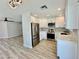 Modern kitchen featuring stainless steel appliances, white cabinetry, and light countertops and flooring at 3014 W Zachary Dr, Phoenix, AZ 85027