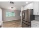 Modern kitchen with stainless steel appliances, white cabinets, and open layout to the dining room at 3014 W Zachary Dr, Phoenix, AZ 85027
