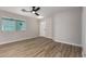 Bright living room featuring sleek hardwood floors, a modern ceiling fan, and ample natural light at 3014 W Zachary Dr, Phoenix, AZ 85027