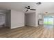 Open-concept living room with hardwood floors, modern lighting, and access to kitchen and bathroom at 3014 W Zachary Dr, Phoenix, AZ 85027