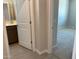 View into bathroom with double sink vanity, neutral paint, carpeted bedroom and tiled floors at 31762 N Bandit Rd, San Tan Valley, AZ 85143