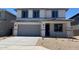 Charming two-story home with a neutral color scheme, attached garage, and simple landscaping at 31762 N Bandit Rd, San Tan Valley, AZ 85143