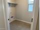 Laundry room with tiled floor, open shelving, and in-wall connections at 31762 N Bandit Rd, San Tan Valley, AZ 85143