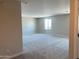 Spacious loft area with neutral carpet, paint, and a window allowing for plenty of light at 31762 N Bandit Rd, San Tan Valley, AZ 85143