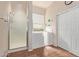 Accessible bathroom with walk-in shower, safety features, and natural light from a window at 3553 W Dancer Ln, San Tan Valley, AZ 85144