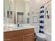 Well-lit bathroom with a vanity, a toilet, a tub and shower at 3553 W Dancer Ln, San Tan Valley, AZ 85144