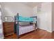 Bedroom with a bunk bed, hard wood floors, a dresser and a closet at 3553 W Dancer Ln, San Tan Valley, AZ 85144