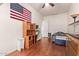 Bright bedroom featuring hard wood floors, ceiling fan, and a bright window at 3553 W Dancer Ln, San Tan Valley, AZ 85144