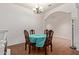 Cozy dining area features a charming chandelier, wooden table, and bright blue tablecloth at 3553 W Dancer Ln, San Tan Valley, AZ 85144