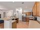 Spacious kitchen with stainless steel refrigerator, oak cabinets, and a breakfast bar at 3553 W Dancer Ln, San Tan Valley, AZ 85144