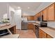 Bright kitchen showcases stainless steel appliances, wooden cabinets, and ample counter space at 3553 W Dancer Ln, San Tan Valley, AZ 85144