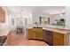 Bright kitchen boasts natural wood cabinets, stainless steel appliances, and an adjacent breakfast nook at 3553 W Dancer Ln, San Tan Valley, AZ 85144