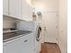 Functional laundry room with a washer, a dryer, cabinets, and an exterior door at 3553 W Dancer Ln, San Tan Valley, AZ 85144