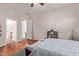 Spacious bedroom with wood floors, doorway view to en-suite bathroom, and natural light at 3553 W Dancer Ln, San Tan Valley, AZ 85144