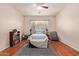 Inviting bedroom boasts ceiling fan, wood floors, plush rug and ample natural light at 3553 W Dancer Ln, San Tan Valley, AZ 85144