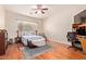 Serene main bedroom with hardwood floors, ceiling fan, and cozy seating area at 3553 W Dancer Ln, San Tan Valley, AZ 85144
