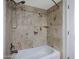 Close-up of shower/tub combo with unique patterned tile and chrome showerhead at 3619 E Monterosa St # 202, Phoenix, AZ 85018