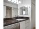 Bathroom with granite countertops, black faucet and washer/dryer unit on the left at 3619 E Monterosa St # 202, Phoenix, AZ 85018