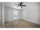 This bedroom boasts neutral paint, ceiling fan, wood flooring, and large windows at 3619 E Monterosa St # 202, Phoenix, AZ 85018