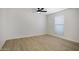 Well-lit bedroom with light wood floors, white walls, a ceiling fan and one window at 3619 E Monterosa St # 202, Phoenix, AZ 85018