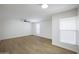 This bedroom boasts neutral paint, ceiling fan, wood flooring, and large windows at 3619 E Monterosa St # 202, Phoenix, AZ 85018