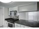 Modern kitchen featuring stainless steel appliances, granite countertops, and white cabinets at 3619 E Monterosa St # 202, Phoenix, AZ 85018