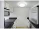 Galley kitchen featuring granite countertops, stainless steel refrigerator, and white cabinets at 3619 E Monterosa St # 202, Phoenix, AZ 85018