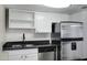 Modern kitchen featuring stainless steel appliances, granite countertops, and white cabinets at 3619 E Monterosa St # 202, Phoenix, AZ 85018