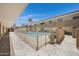A shared community pool enclosed by a metal fence with a multi-story building at 3619 E Monterosa St # 202, Phoenix, AZ 85018