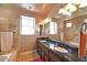 Stylish bathroom features a granite countertop, dual sinks, a large mirror, and a tiled shower and bathtub at 3804 E Camelback Rd, Phoenix, AZ 85018