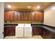 Well-organized laundry room with ample cabinet space, granite countertops, washer, and dryer at 3804 E Camelback Rd, Phoenix, AZ 85018