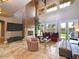 Elegant living room with high ceilings, a stone fireplace, french doors, tile floors, and custom furnishings at 3804 E Camelback Rd, Phoenix, AZ 85018