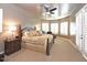 Serene main bedroom with a king-size bed, sitting area, carpet flooring, neutral colors, and lots of natural light at 3804 E Camelback Rd, Phoenix, AZ 85018