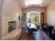 Comfortable home office featuring a stone fireplace, hardwood floors, and large windows at 3804 E Camelback Rd, Phoenix, AZ 85018