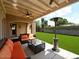 Inviting covered patio featuring a ceiling fan, outdoor seating, and a heater overlooking the green backyard at 3804 E Camelback Rd, Phoenix, AZ 85018