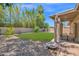 Charming backyard with gravel landscaping, covered patio, and a well-manicured lawn for outdoor activities at 3919 E Larkspur Dr, Phoenix, AZ 85032