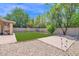 Well-manicured backyard with artificial turf, gravel accents, patio, and block wall for privacy at 3919 E Larkspur Dr, Phoenix, AZ 85032