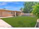 This backyard features a well-maintained artificial lawn and a covered patio, perfect for outdoor enjoyment at 3919 E Larkspur Dr, Phoenix, AZ 85032