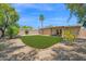 This backyard has a lush green lawn and mature trees, providing a serene and private outdoor space at 3919 E Larkspur Dr, Phoenix, AZ 85032