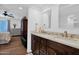Bathroom featuring dual sinks, dark wood cabinets, marble counters, and a door leading to the bedroom at 3919 E Larkspur Dr, Phoenix, AZ 85032