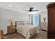 This bedroom features a ceiling fan, wood floors, and a beautiful view of the backyard at 3919 E Larkspur Dr, Phoenix, AZ 85032