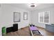 Bright bedroom features plenty of light, wood-look tile flooring, and space for exercise equipment at 3919 E Larkspur Dr, Phoenix, AZ 85032