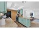 Charming kitchen featuring blue cabinets, granite countertops, a tile backsplash, and stainless steel appliances at 3919 E Larkspur Dr, Phoenix, AZ 85032