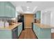 Charming kitchen featuring blue cabinets, granite countertops, a tile backsplash, and stainless steel appliances at 3919 E Larkspur Dr, Phoenix, AZ 85032