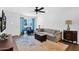 Bright living room features wood floors, a ceiling fan, comfortable seating, and backyard view at 3919 E Larkspur Dr, Phoenix, AZ 85032