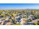 An aerial view showcases a home in a neighborhood with lush landscaping and mountain views in the distance at 4131 E Roma Ave, Phoenix, AZ 85018