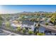 An aerial view of a white home and neighborhood. The mountains are visible in the distance at 4131 E Roma Ave, Phoenix, AZ 85018