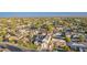 An aerial view showcases a home in a neighborhood with lush landscaping and mountain views in the distance at 4131 E Roma Ave, Phoenix, AZ 85018